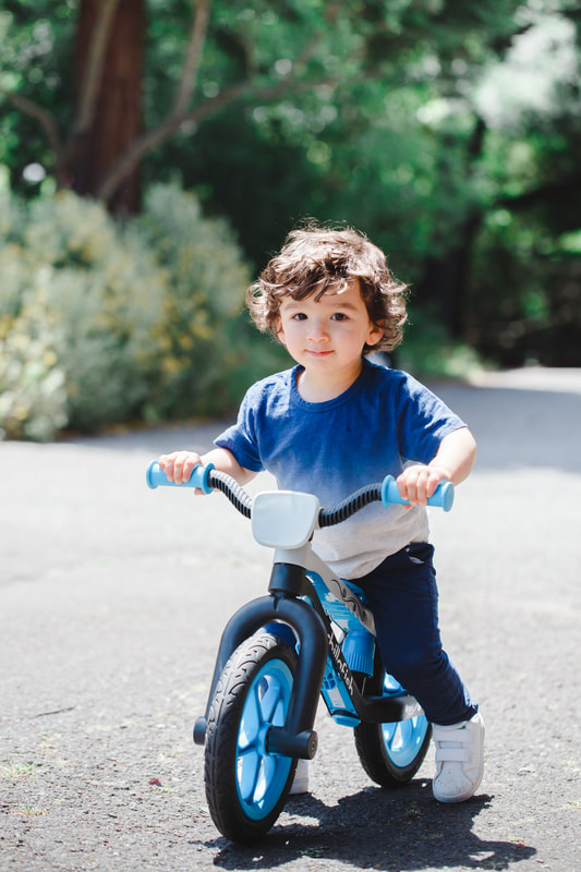Toddler boy with balance bike, portrait photography, fun, lifestyle photo session in Berkeley.  